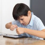 Female Psychologist Working with Boy Suffering from Autistic Disorder