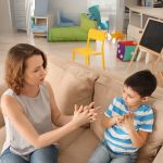 Female Psychologist Working with Boy Suffering from Autistic Disorder